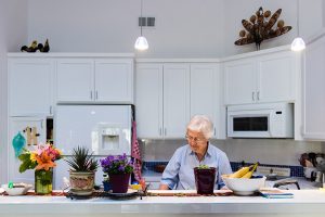 Joan Stek, 90, works in her kitchen at Glacier Circle in Davis, Calif., on Oct. 23, 2017. (Heidi de Marco/KHN)